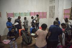 The surveillance team in Itipo meet at the end of the day to tally data and plan for the next day’s visits.